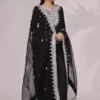 Model wearing the Inaya Black & White Raw Silk Set with mirror work, ideal for weddings, formal gatherings, and festive occasions. A perfect blend of traditional and modern elegance.
