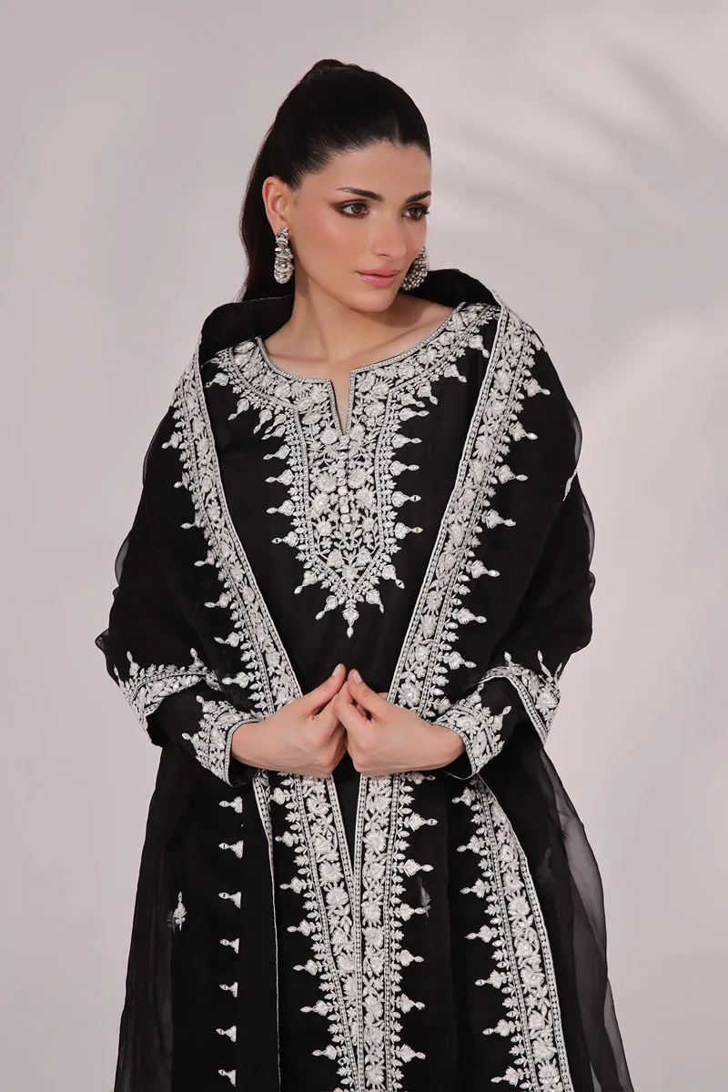 Close-up of the luxurious raw silk fabric of the Inaya set, showcasing its soft texture and high-quality craftsmanship with elegant embroidery and mirror work.