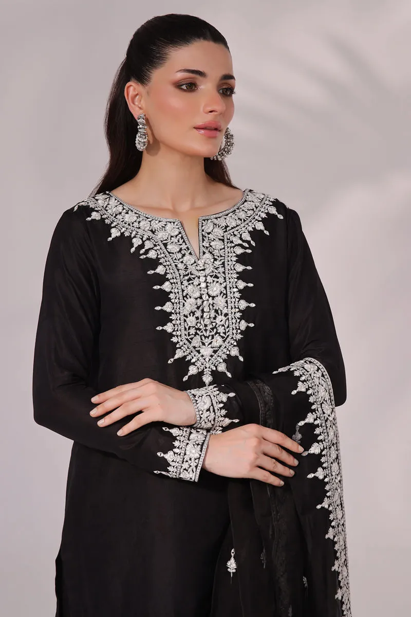 Close-up of the beautifully embroidered neckline with delicate mirror work on the black and white raw silk Inaya set, exuding timeless elegance for special events.