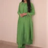 Don’t Miss Out – Apple Green Dress in Luxe Raw Silk Elegance Apple Green Raw Silk Dress hanging on a hanger, showcasing luxurious fabric and elegant design perfect for weddings and formal gatherings."