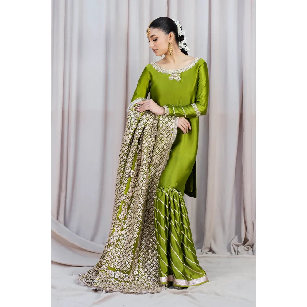 Luxury Rose Silk Gharara with Hand-Embellished Organza Dupatta Elegant rose gold tissue silk kameez with delicate neckline and sleeve embellishments, ideal for festive celebrations.