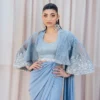 Sky Blue Fusion Saree with Hand-Embellished Cape – Luxury Traditional Wear Occasion Styling "Sky Blue Fusion Saree styled for a wedding guest look, combining traditional embroidery and modern elements like the belt and organza cape."