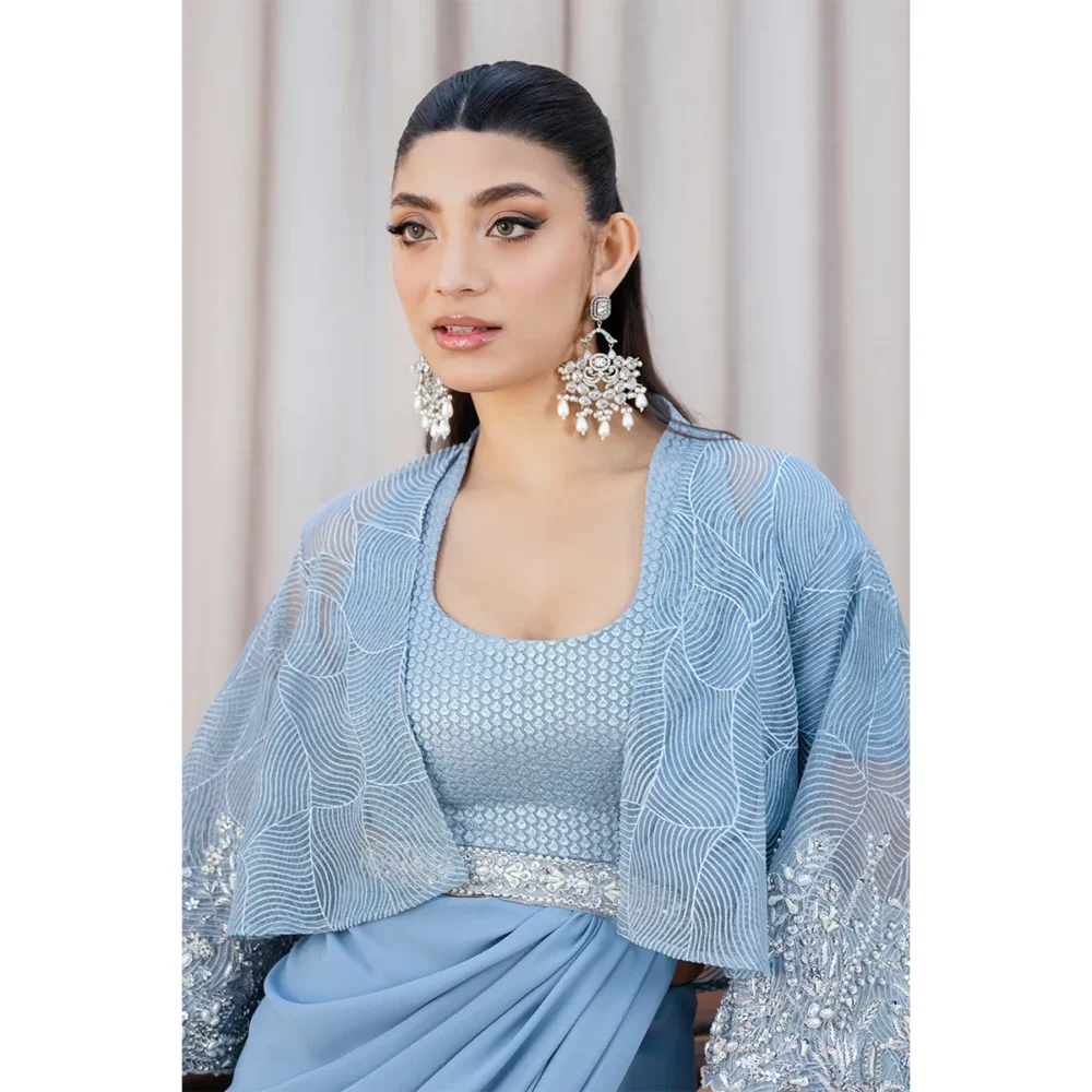 Sky Blue Fusion Saree with Hand-Embellished Cape – Luxury Traditional Wear Close-up of Saree Embroidery "Intricate embroidery on the sky blue fusion saree, showcasing handcrafted craftsmanship with pearl and silver embellishments."