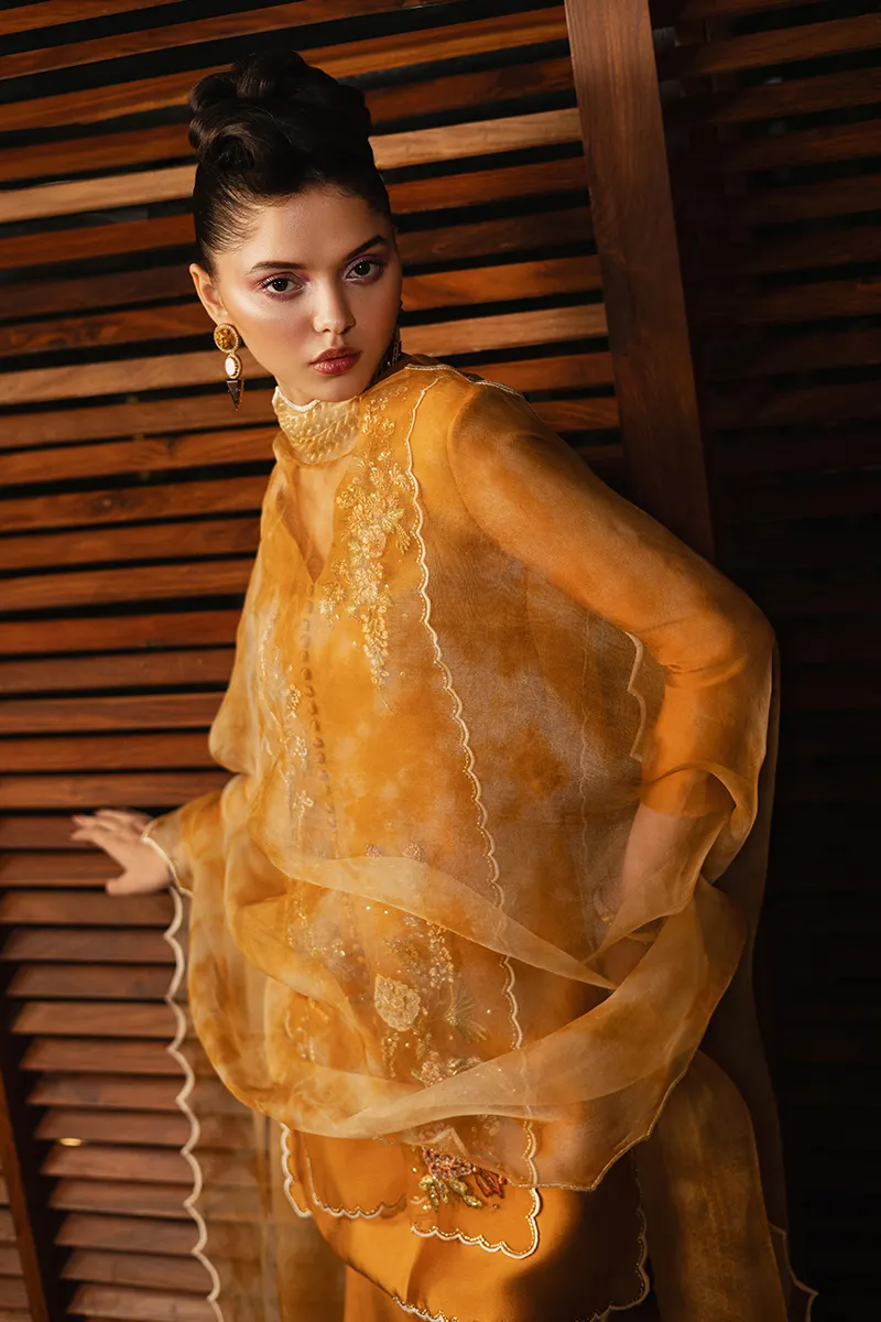 The luxurious boot-cut trouser, embroidered with three-dimensional florals, paired with the embroidered organza shirt, creating a royal look.