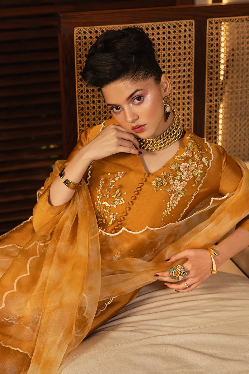 A stunning full-length view of the embroidered organza shirt with boot-cut trouser, exuding sophistication and contemporary glamour.