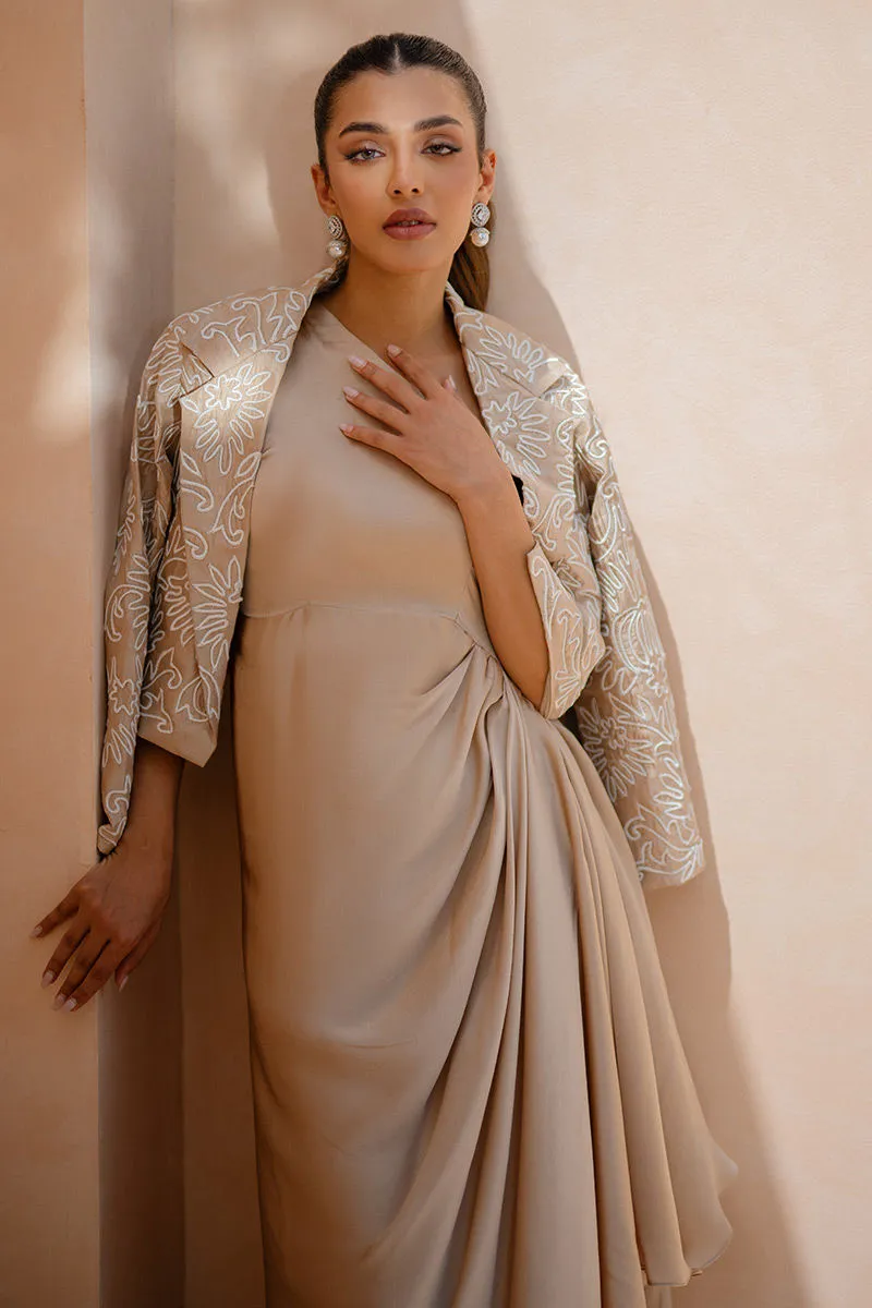 Back view showcasing the graceful drape of the taupe silk dress.