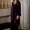 "Elegant velvet dress in royal purple with handcrafted pearl tiki stones"