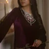 "Model wearing luxurious velvet dress with regal purple color"