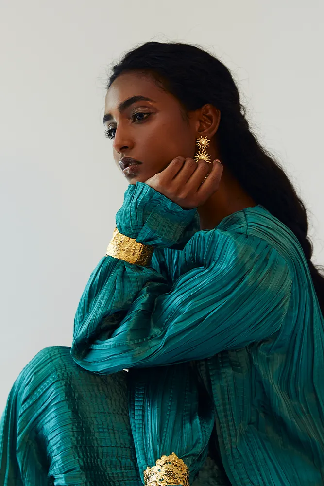 Teal Satin Pleated Gown with Billowing Sleeves and Gold Cuffs