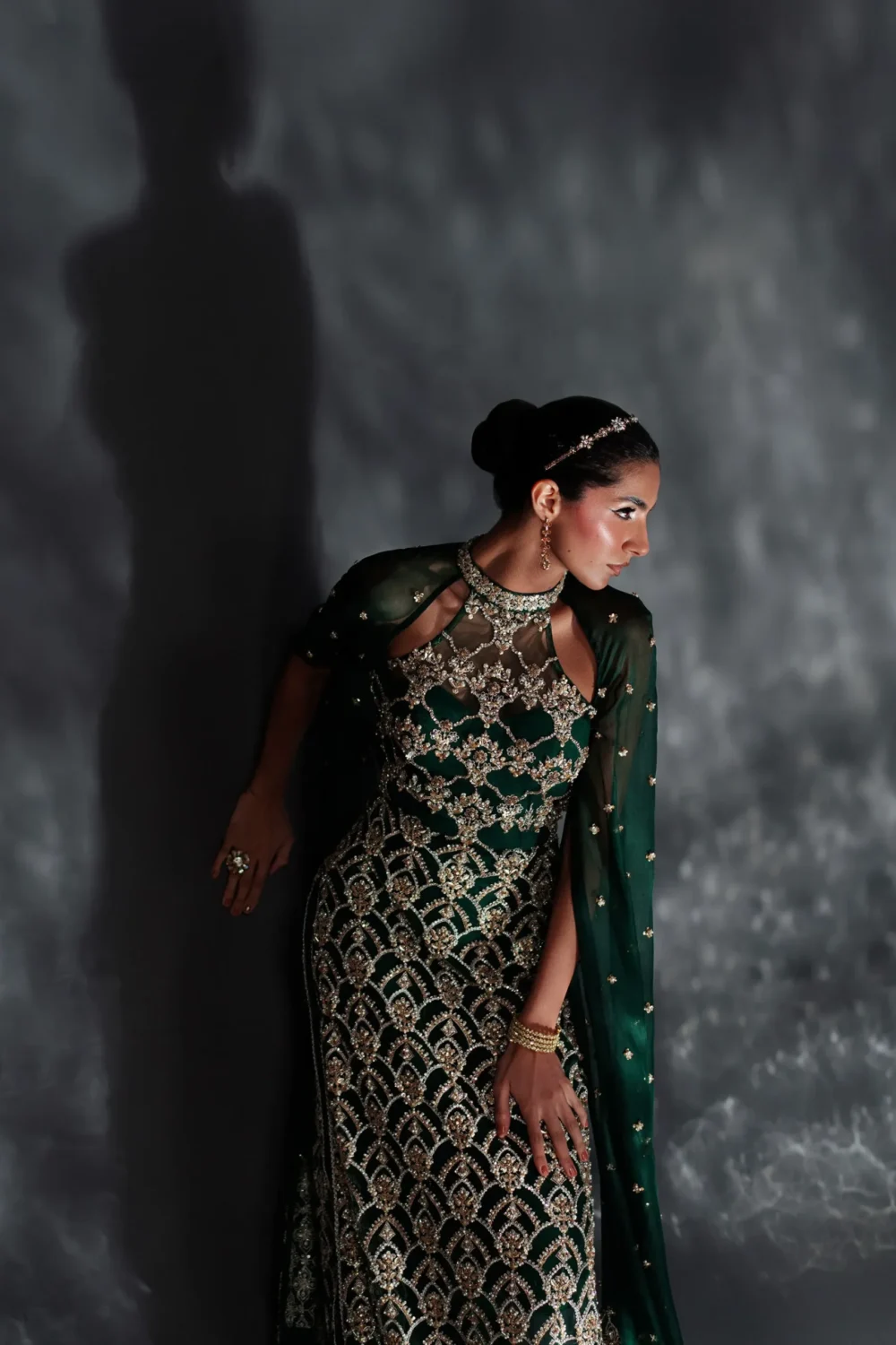 Emerald green dress showcasing its stunning silhouette from a side view.