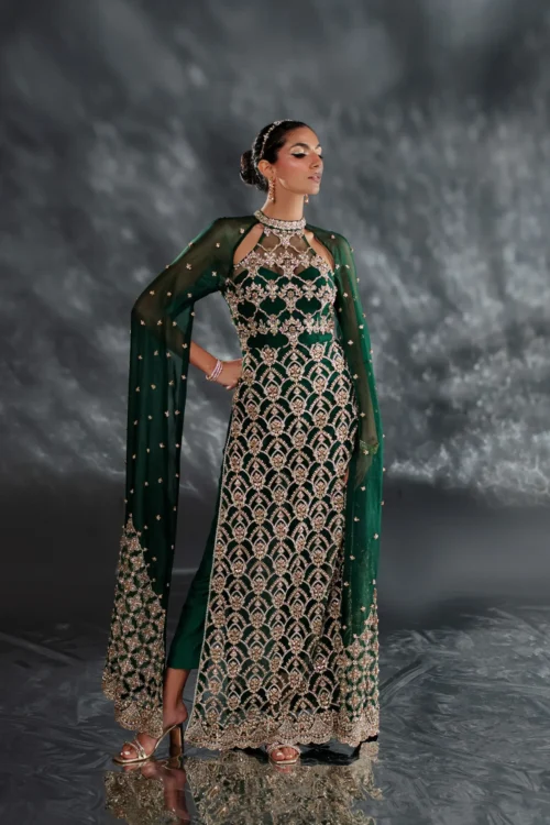 Emerald green dress with intricate crystal embellishments in a close-up shot.