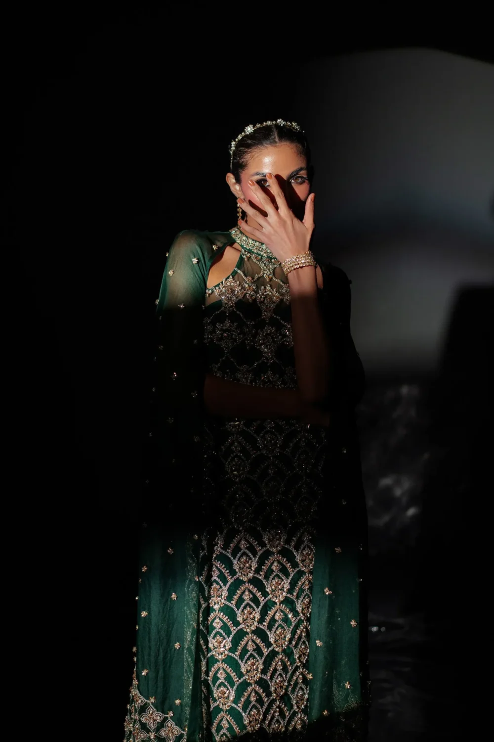 Emerald green dress featuring handcrafted embroidery in a detailed close-up.