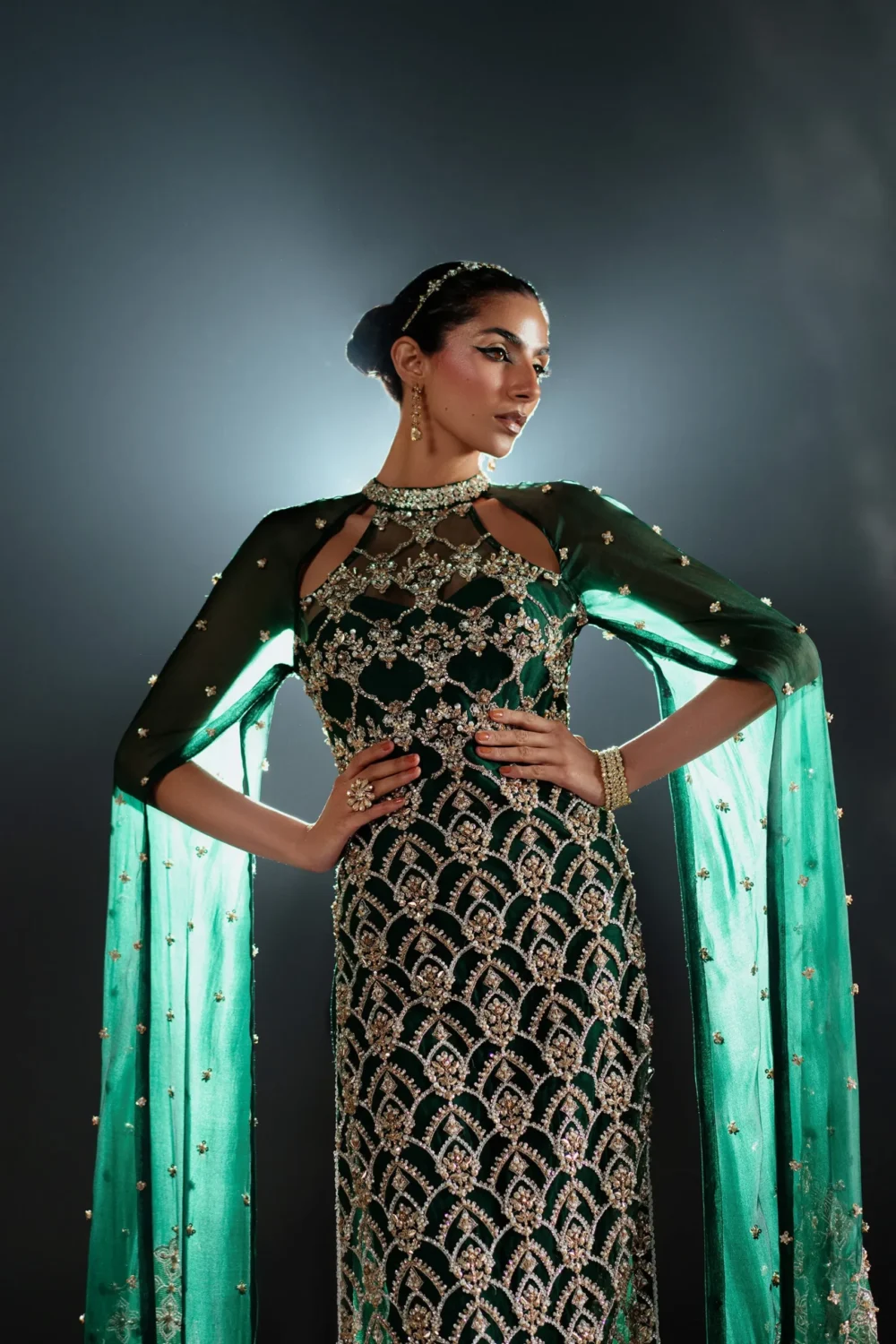 Emerald green dress worn by a model at an elegant evening event.