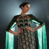 Emerald green dress worn by a model at an elegant evening event.