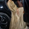 GOLD MASURI NET KALIDAR DRESS worn by a model at an elegant event.