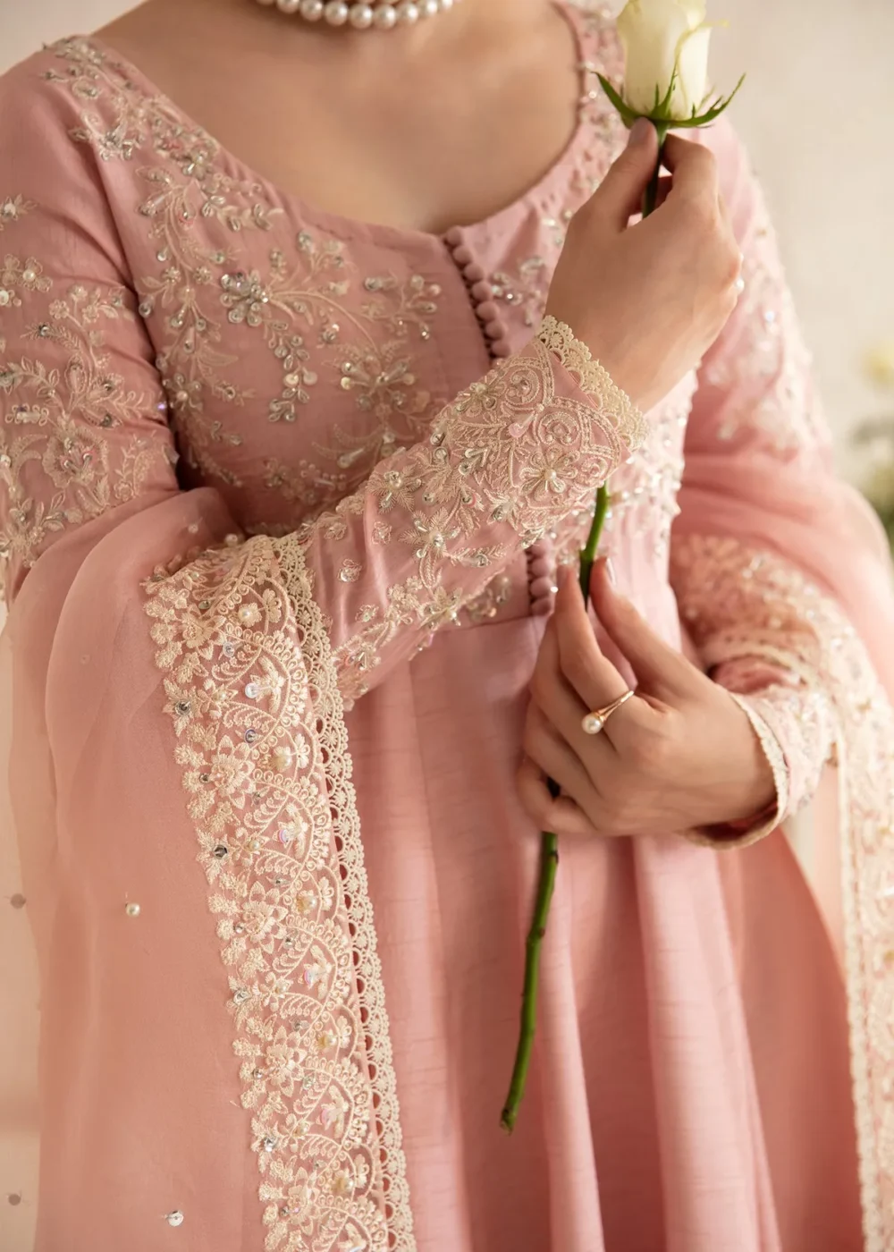 "Blush pink pishwas with intricate embroidery and hand embellishments"