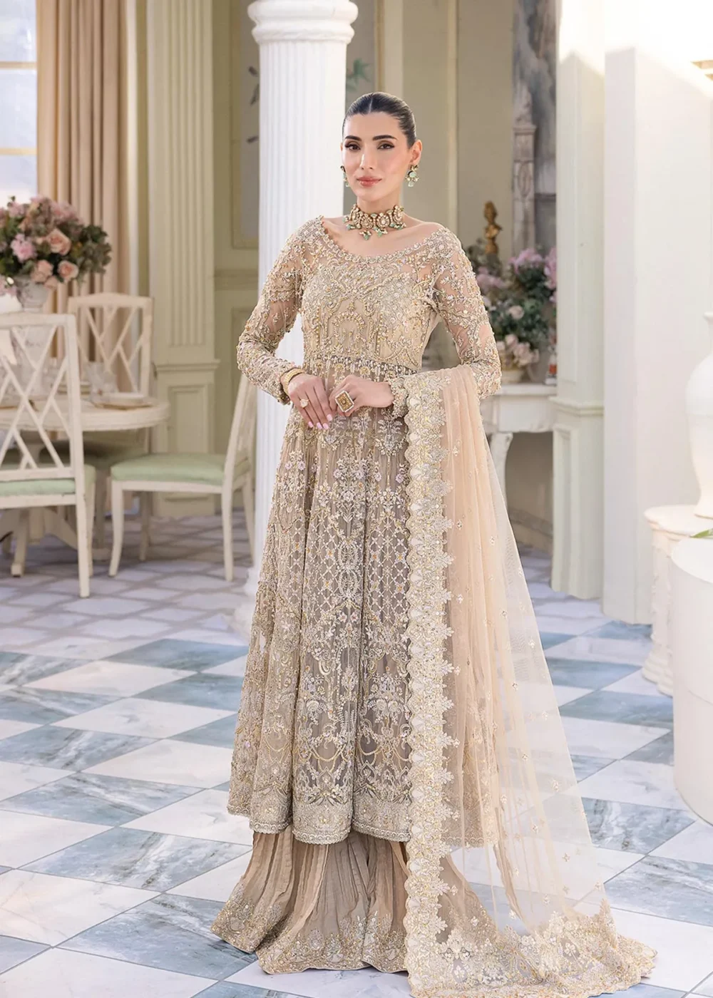 Nude Peshwas ensemble with delicate embroidery and shimmering embellishments