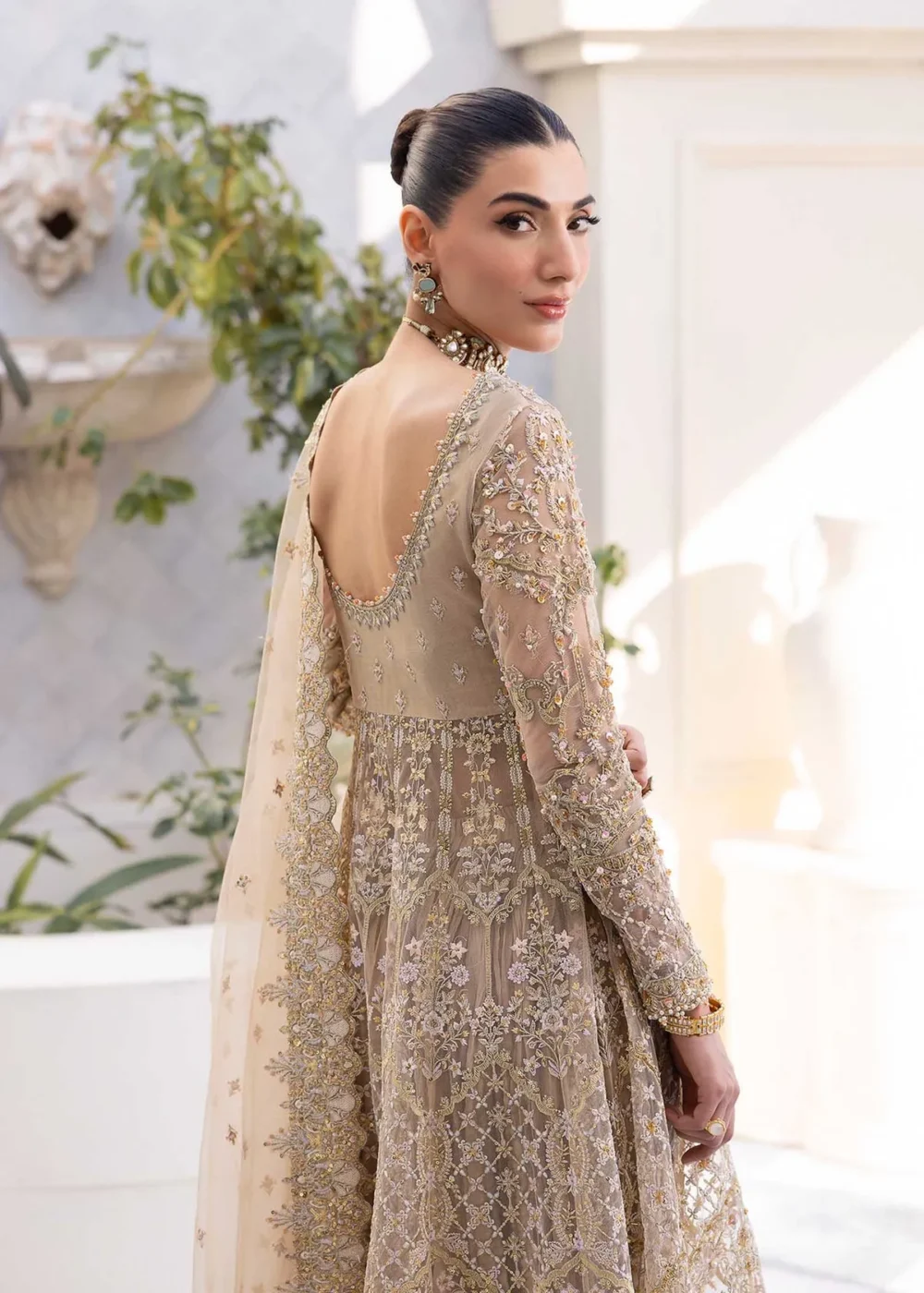 Nude Peshwas ensemble with delicate embroidery and shimmering embellishments