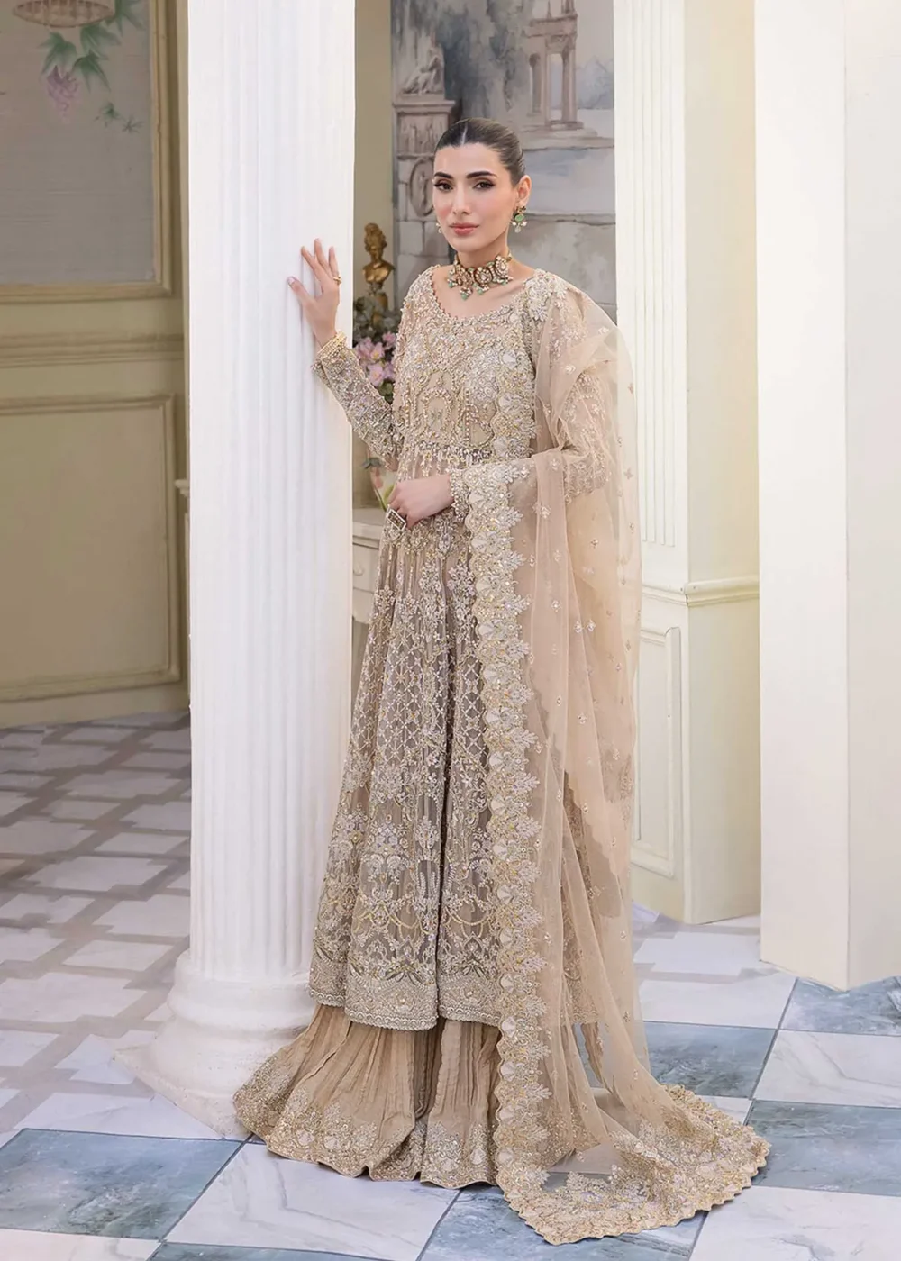 Nude Peshwas ensemble with delicate embroidery and shimmering embellishments