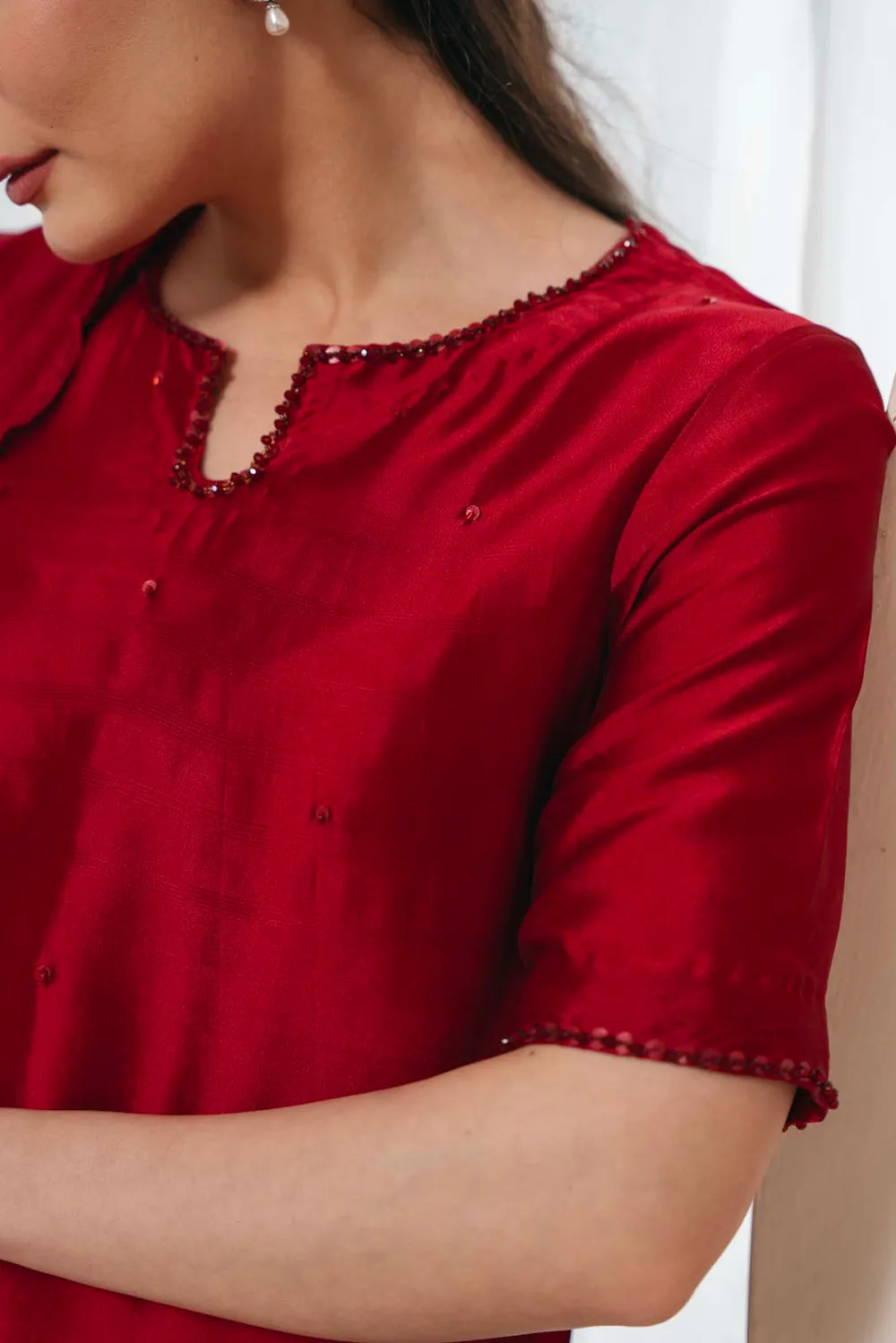 "Red Sheesha Silk Shirt with Crystal and Bead Embellishments on Keyhole Neckline."