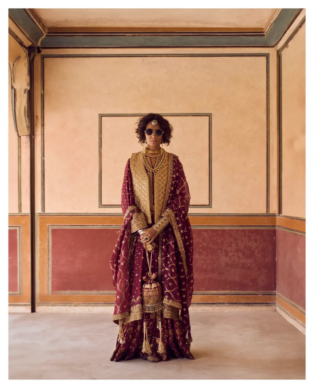 The model elegantly displays the Maroon Jamavar Lehenga Set, capturing attention with its rich colors and detailed embroidery.