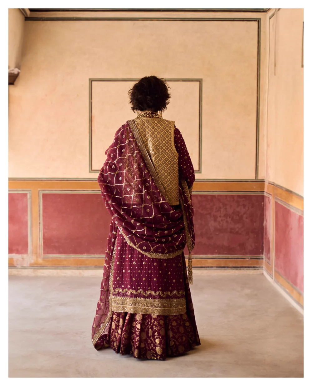 The Maroon Jamavar Lehenga Set is highlighted with its exquisite craftsmanship and luxurious fabric.