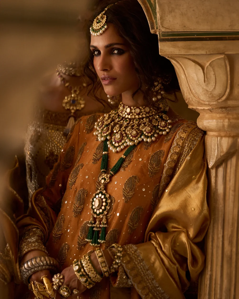 Mustard & Olive Ensemble featuring a pure mysori net shirt with zardozi work, olive green jamavar dhaka pajama, and mustard lamè tissue dupatta.