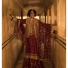 The intricate details of the Maroon Jamavar Lehenga Set are beautifully showcased as the model stands confidently.