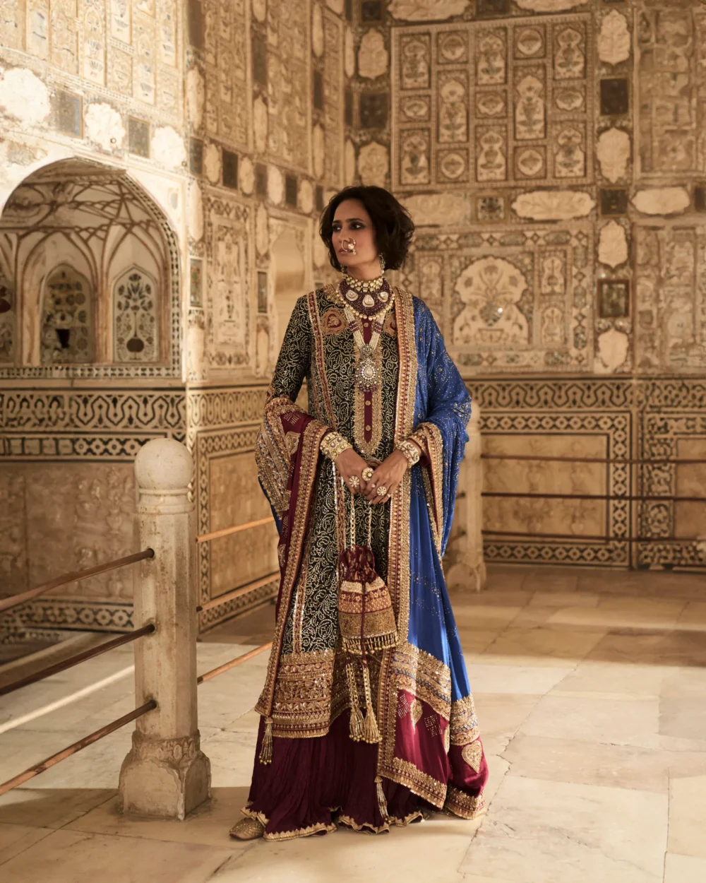 The model elegantly displays the Black Charmeuse Chunri Lehenga Set, capturing attention with its rich colors and detailed embroidery. The model elegantly displays the Black Charmeuse Chunri Lehenga Set, capturing attention with its rich colors and detailed embroidery.