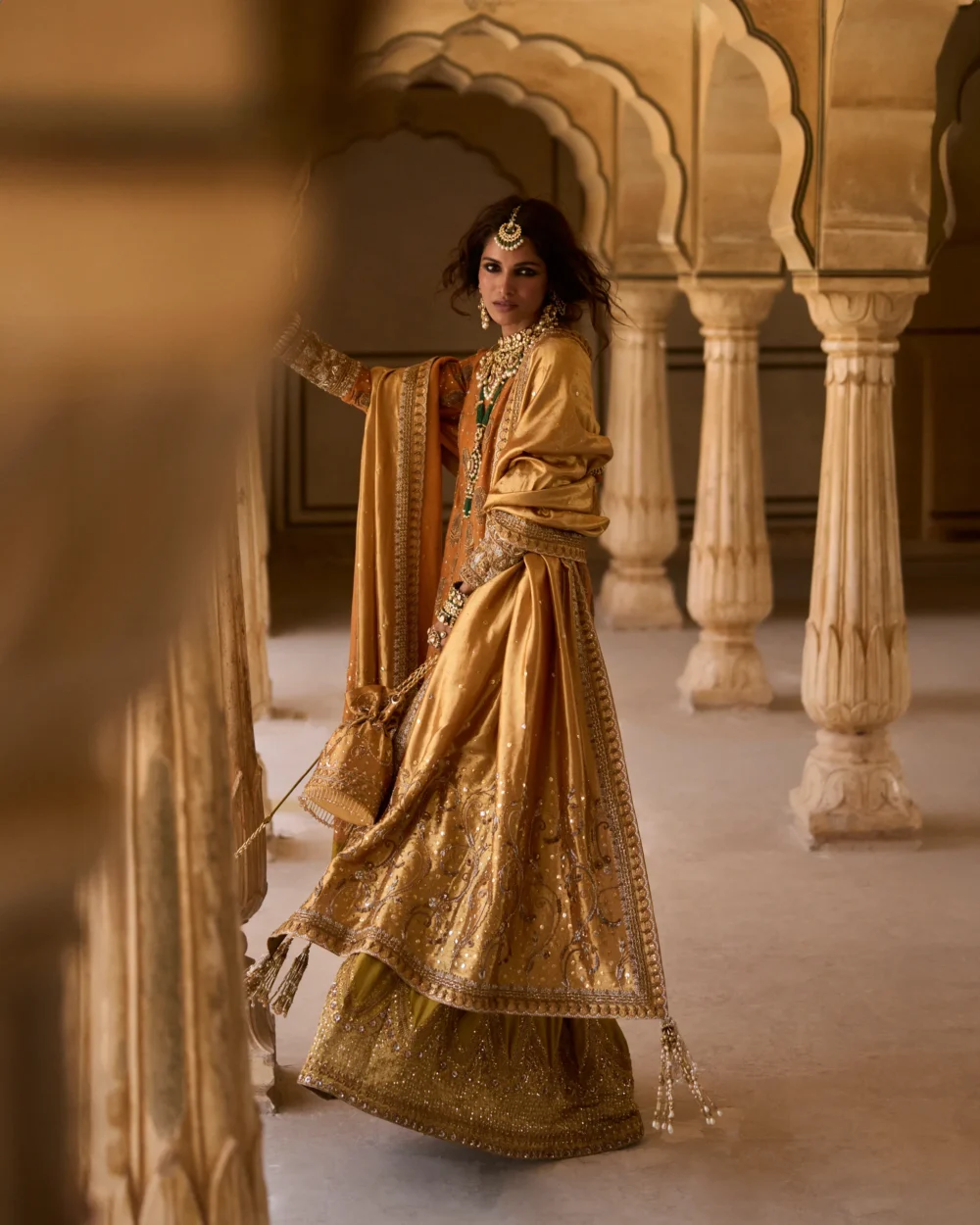 Mustard & Olive Ensemble featuring a pure mysori net shirt with zardozi work, olive green jamavar dhaka pajama, and mustard lamè tissue dupatta.