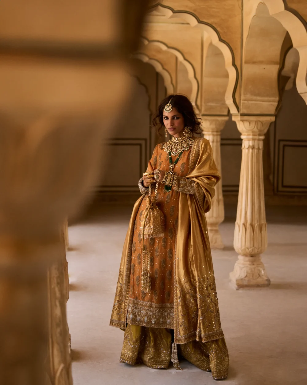 Mustard & Olive Ensemble featuring a pure mysori net shirt with zardozi work, olive green jamavar dhaka pajama, and mustard lamè tissue dupatta.