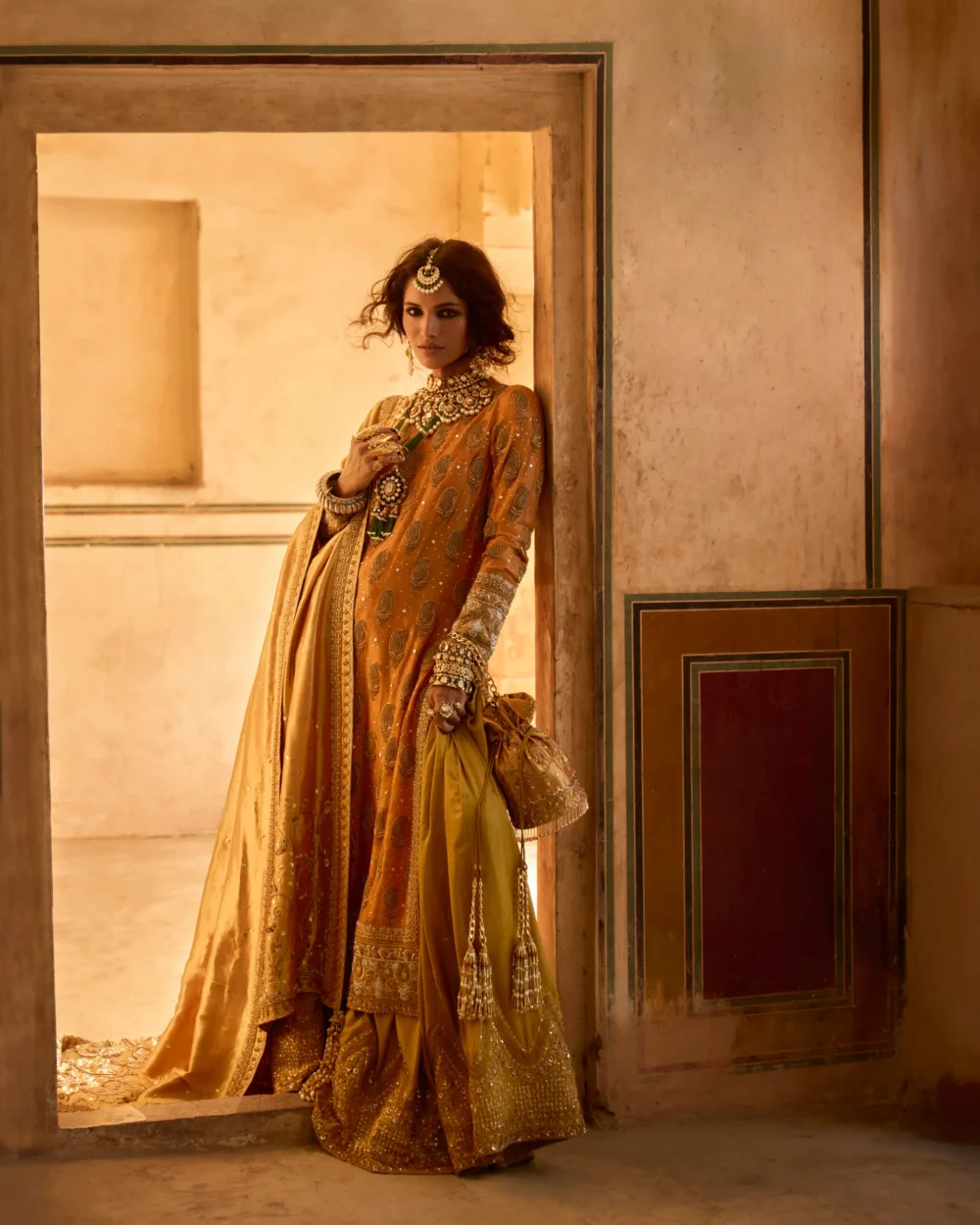 Mustard & Olive Ensemble featuring a pure mysori net shirt with zardozi work, olive green jamavar dhaka pajama, and mustard lamè tissue dupatta.