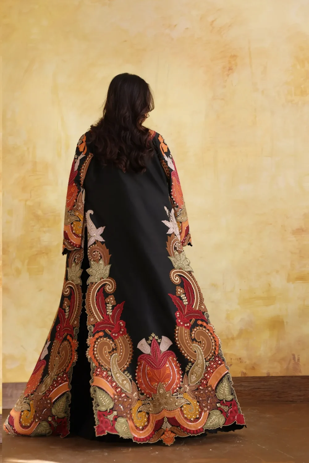 regal embroidered cape gown black orange gold floral motifs luxury design