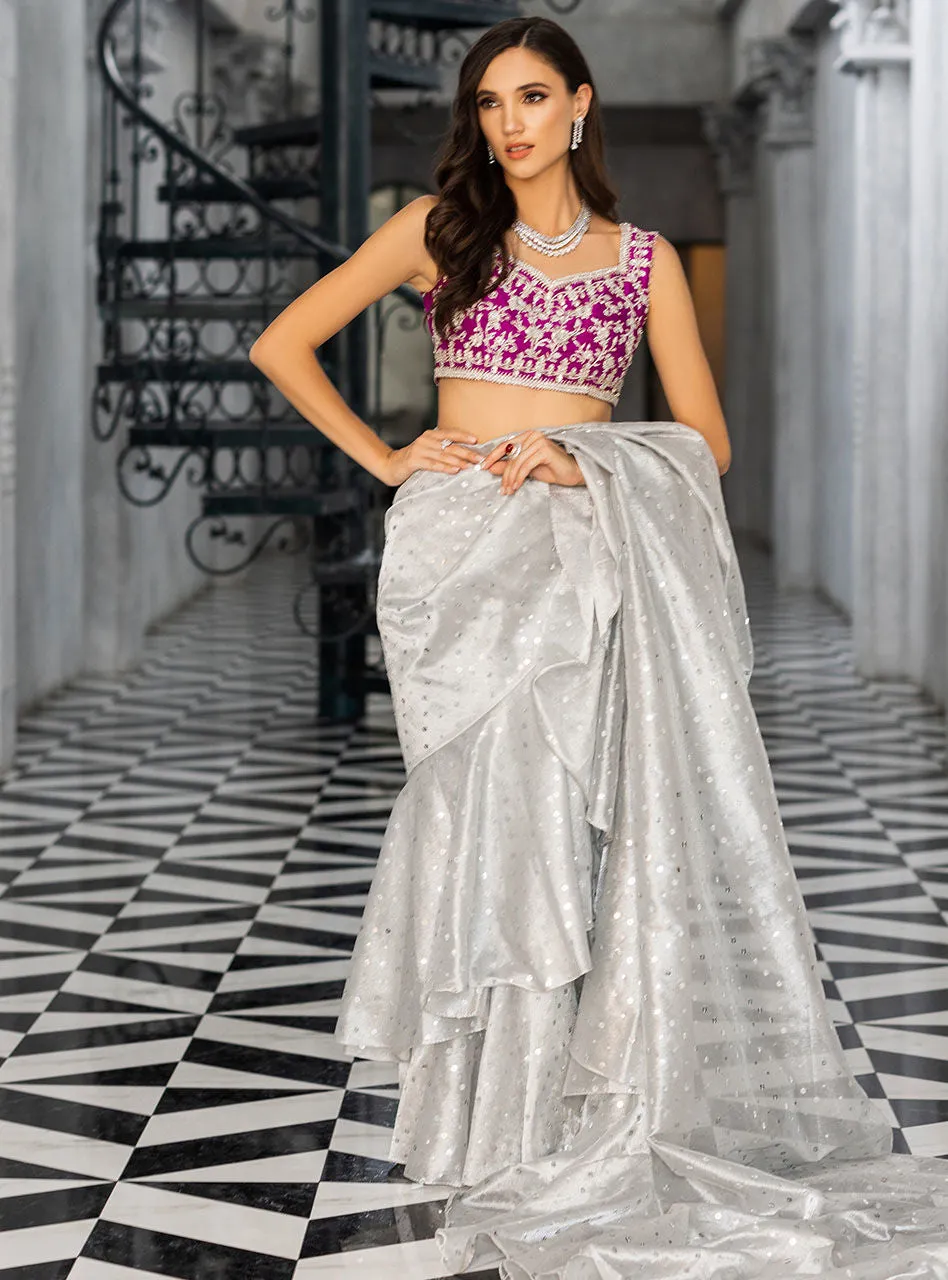 Silver Embellished Saree showcasing the extravagantly draped silhouette and the vibrant magenta blouse.