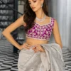 Silver Embellished Saree showcasing the extravagantly draped silhouette and the vibrant magenta blouse.