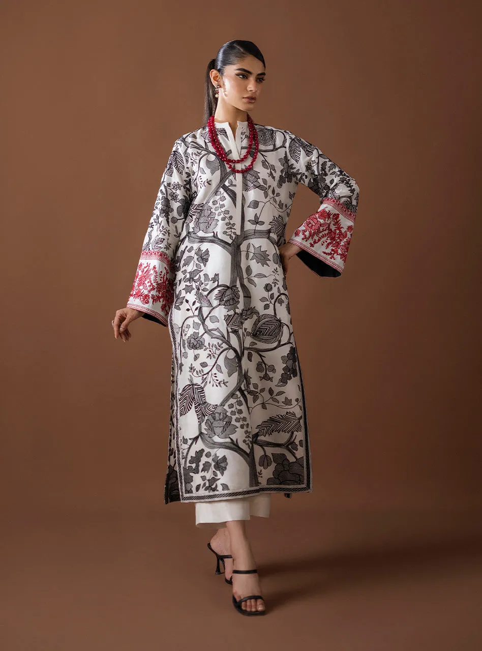 Detail shot of the vibrant red Kantha work border on the sleeve of the Kantha Work Shirt, showing the dramatic color pop. Detail shot of the vibrant red Kantha work border on the sleeve of the Kantha Work Shirt, showing the dramatic color pop.