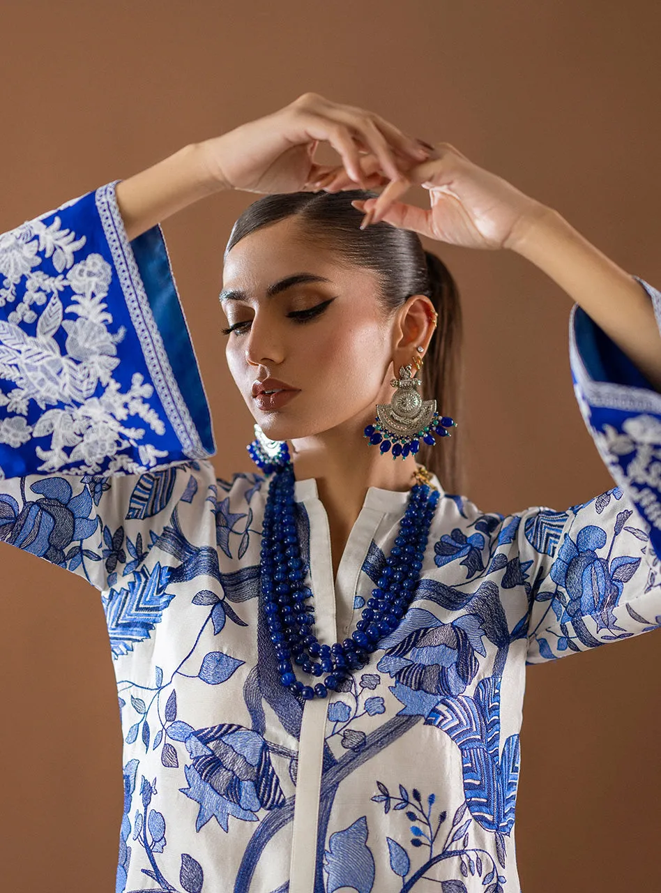 Kantha Work Shirt close-up on the intricate, all-over blue Kantha stitching on the white fabric.