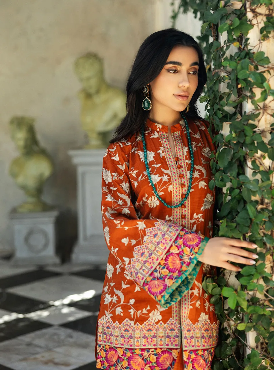 Close-up of the elegant and luxurious Jamawar cuff on the sleeve of the orange embroidered shirt.