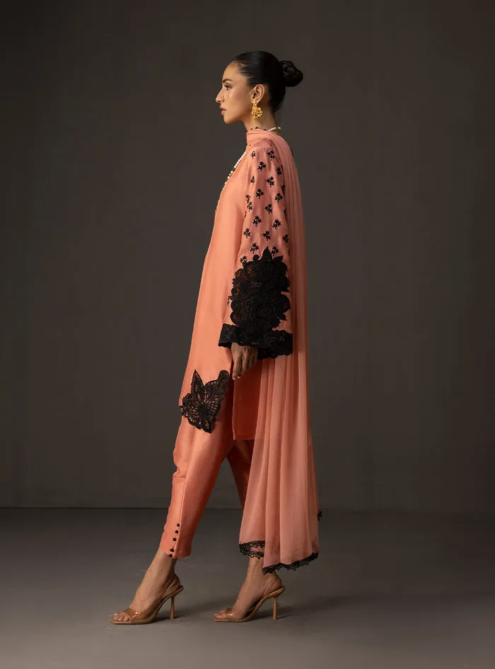 Coral embroidered suit featuring the soft coral tussle silk shirt and matching shalwar.
