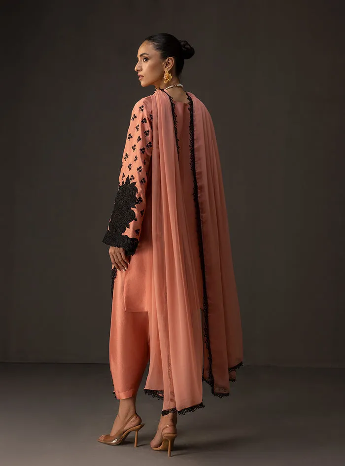 Coral embroidered suit featuring the soft coral tussle silk shirt and matching shalwar.