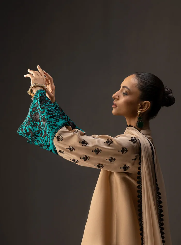 Detail shot of the vibrant teal cuffs with intricate embroidery, a unique feature of the gradient embroidered shirt.