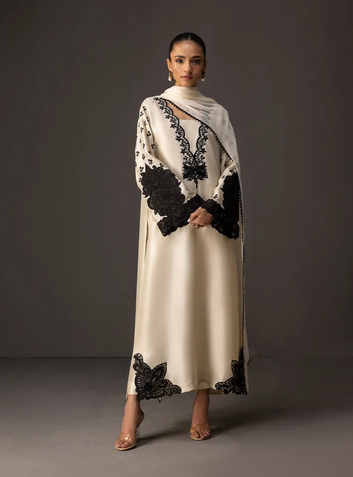 Full view of the ivory embroidered shirt as a complete suit with matching tussle silk pants and chiffon dupatta.