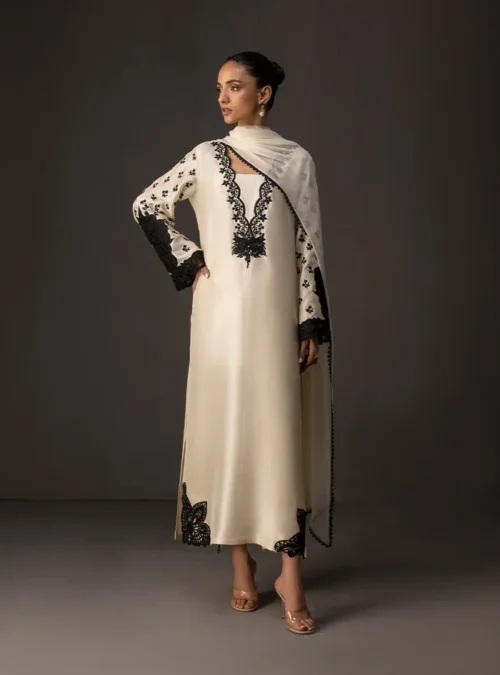 Full view of the ivory embroidered shirt as a complete suit with matching tussle silk pants and chiffon dupatta. Full view of the ivory embroidered shirt as a complete suit with matching tussle silk pants and chiffon dupatta.