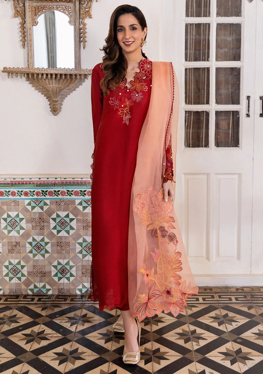 Model in brick red sheesha silk kurta and contrasting coral dupatta with asymmetrical floral embroidery for Eid.