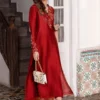 Close-up of floral cutwork on brick red sleeves and pearl accents for luxury Eid 2026 wear.