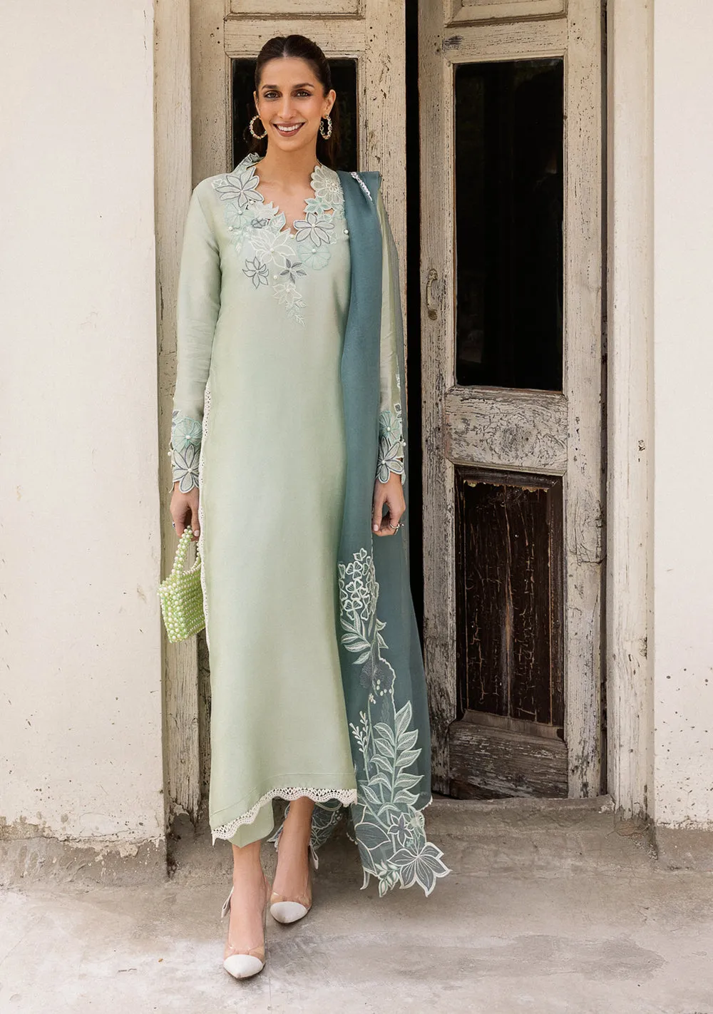 download (21) Close-up of aqua sheesha silk sleeves with intricate cutwork and dainty pearl accents for luxury Eid wear.