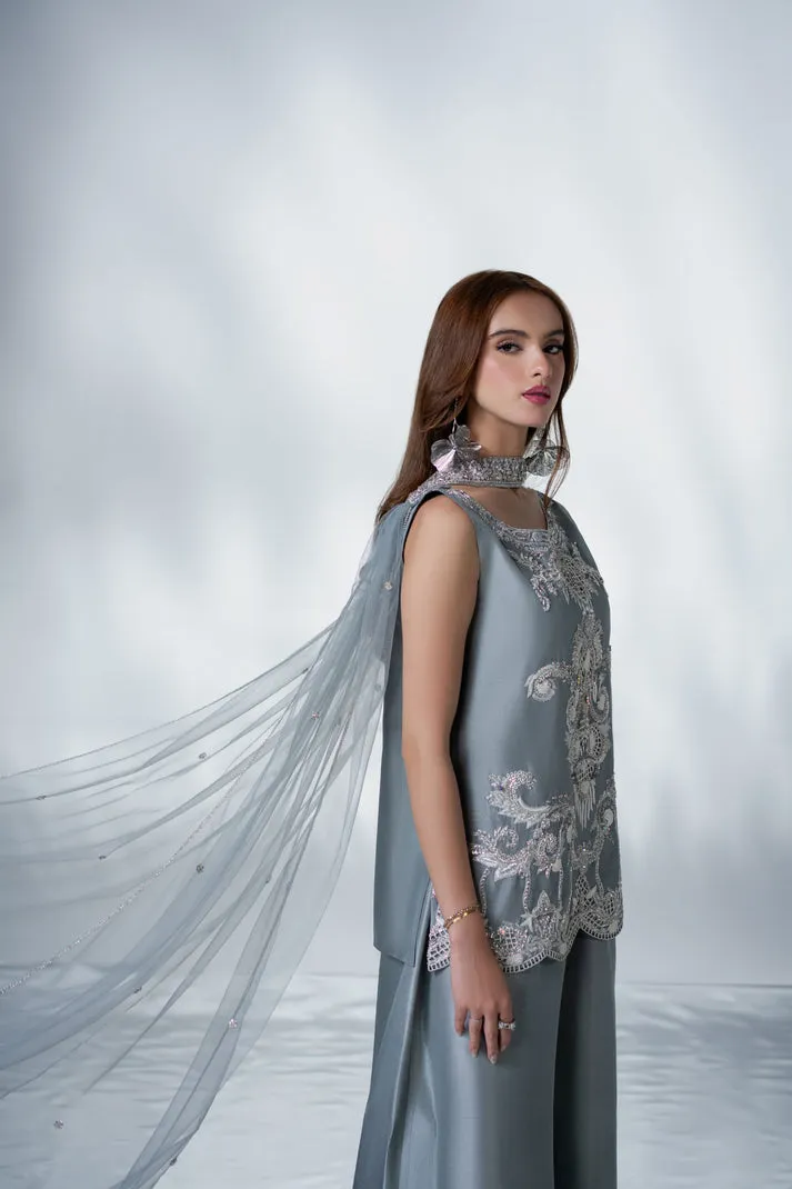 download (27) Close-up of hand-done stone work and crystal detailing on grey raw silk sleeves for luxury Eid 2026 fashion.
