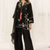 Model in black oversized short kurta with wide-leg kharri shalwar and organza dupatta for Eid 2026 fashion.