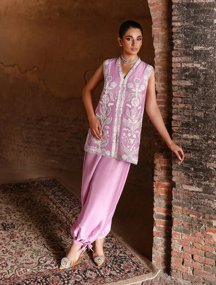 Close-up of hand-embroidered pearls and tilla artistry on white raw silk for luxury Eid 2026 fashion.