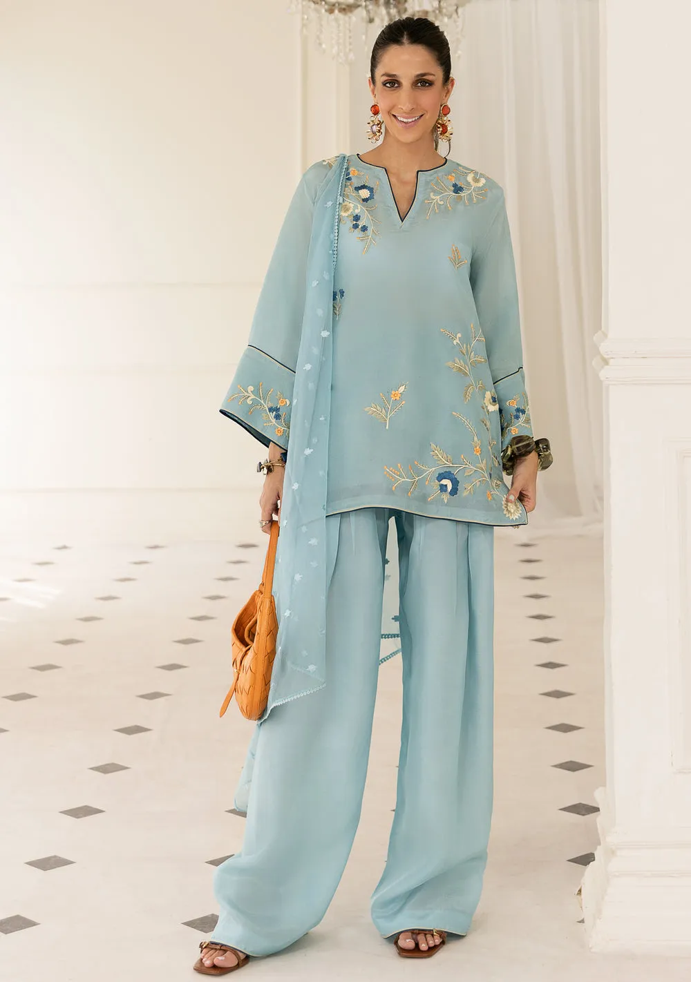 Model wearing Azurea sky blue silk kurta with kharri shalwar and embroidered organza dupatta for Eid 2026 festivities.